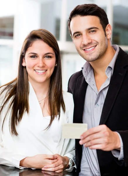 Couple holding a credit card