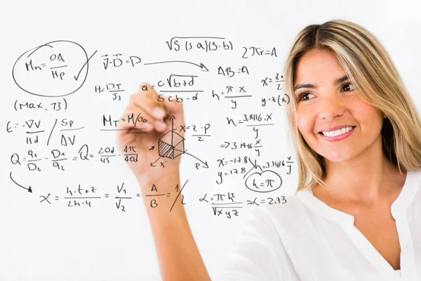 Female student writing formulas