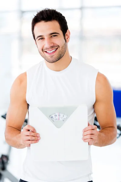 Man holding a weight scale