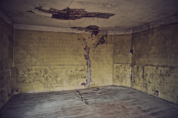 Old room with worn wallpaper and former beauty