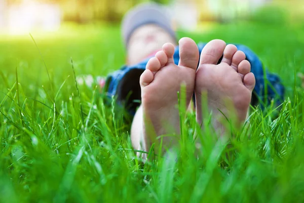 Feet on grass. Family picnic in spring park