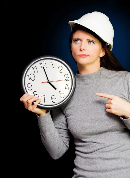 Female Construction Builder Pointing At Clock