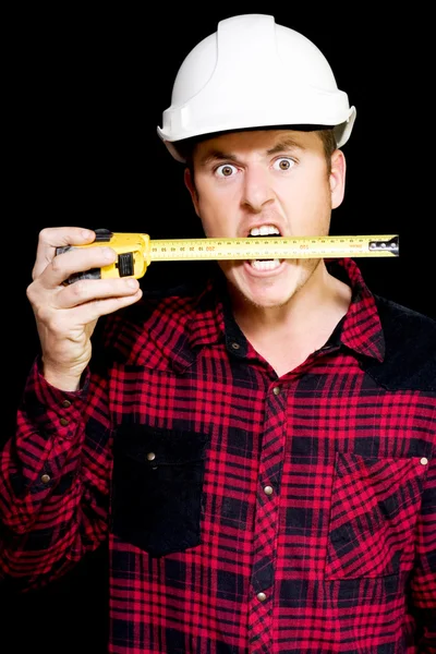 Crazy builder biting his tape measure