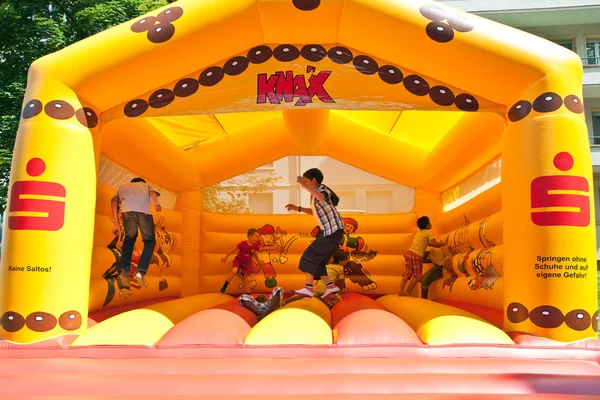 Kids jumping on an inflatable trampoline.