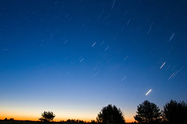 Early morning sky with star trails