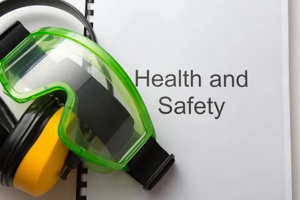 Health and safety register with goggles and earphones