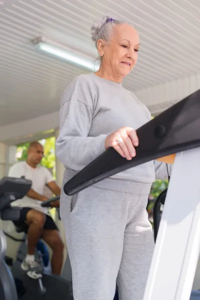 Senior man exercising in wellness club