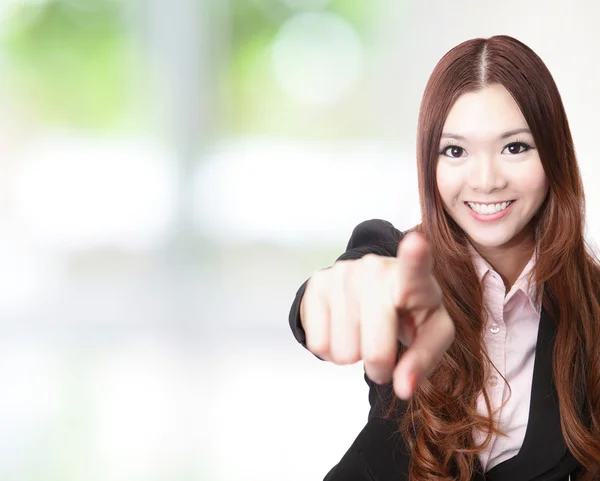 Excited business woman pointing at you and smiling