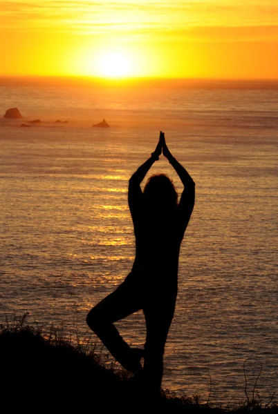 Woman exercising at sunset on the West coast