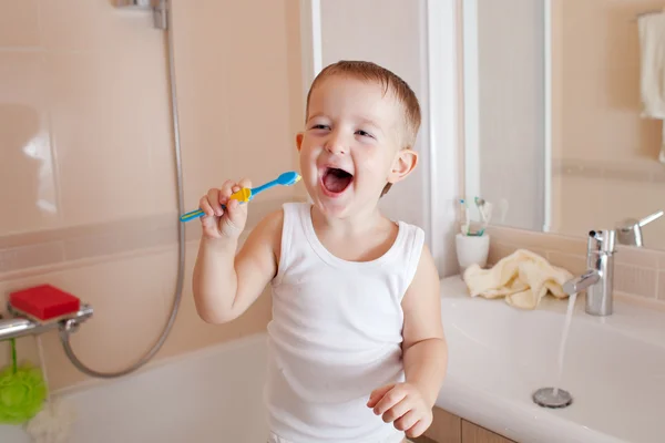 Boy cleaning teeth in bathroom