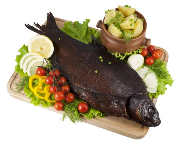Smoked bream on a wooden board with a hot potato in a clay pot,