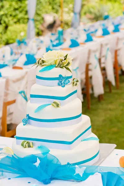 Wedding cake and table setting outdoors