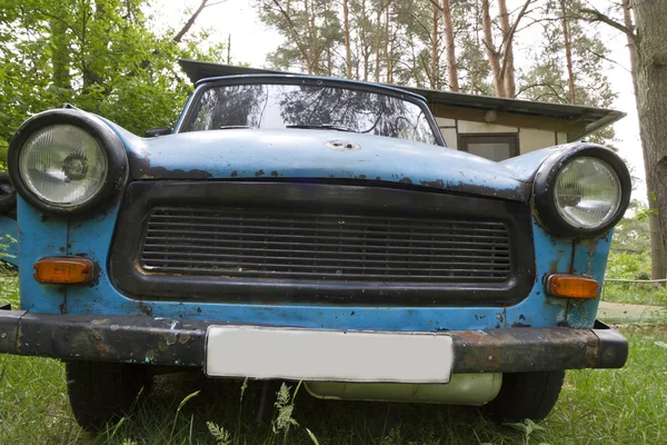 East-German plastic vintage car parked in a garden