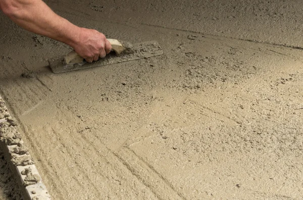 Worker finishing a concrete floor