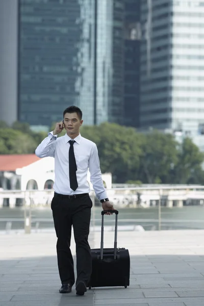 Business man walking and using a Cell Phone