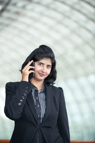 Indian business woman using mobile phone.