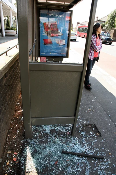 Smashed glass on a local bus stop