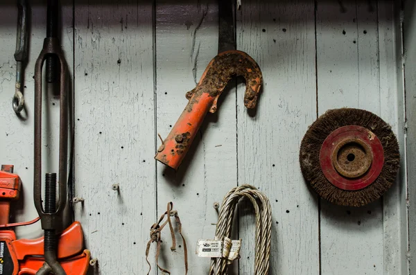 Mechanic tools hanging on wooden wall