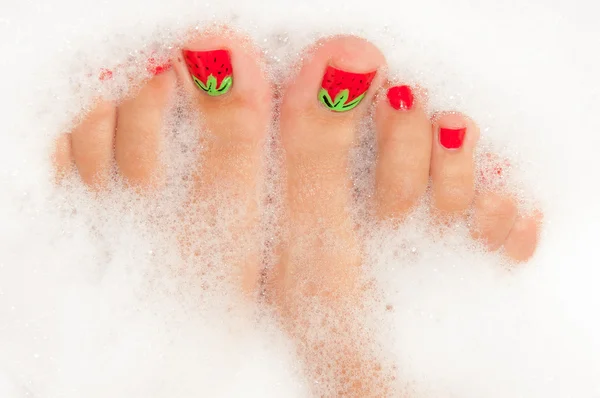 Woman\'s legs into foam bath