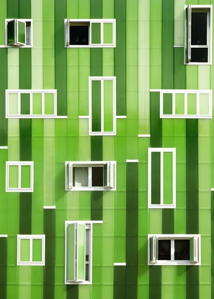 Front windows of a modern green building, green facade