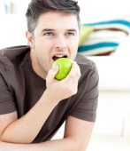 depositphotos_10829988-Young-man-lying-on-the-ground-and-eating-a-green-apple.jpg