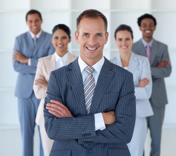 Business manager standing in office leading his team