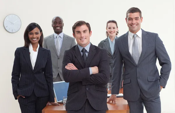 Confident business team standing in a meeting and smiling
