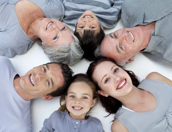 High angle of family lying on floor with heads together