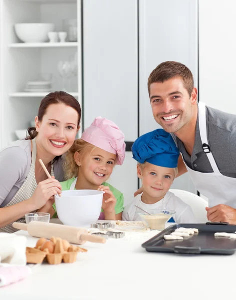 Parents and childrnbaking together in the kitchen