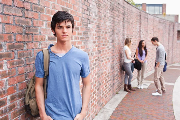 Student posing while his friends are talking — Stock Photo #11193707