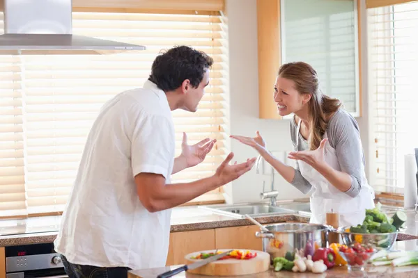 Couple having a fight in the kitchen