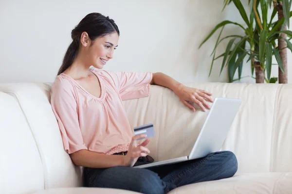 Delighted woman shopping online