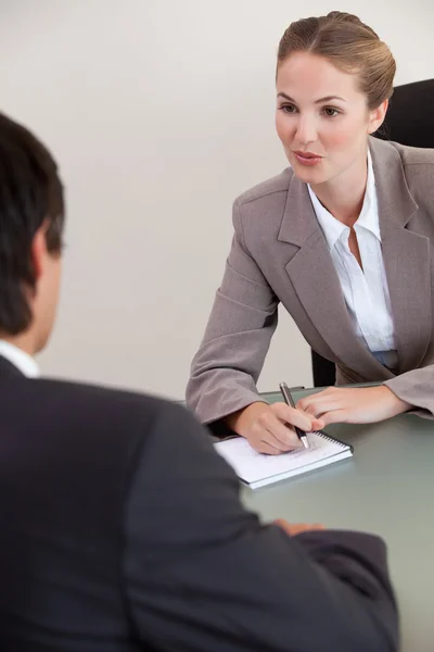 Portrait of a serious manager interviewing a male applicant