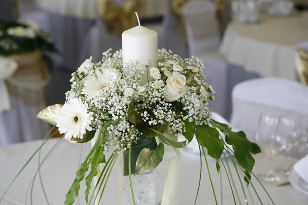 A photo of table setting for a wedding or dinner event, with flowers
