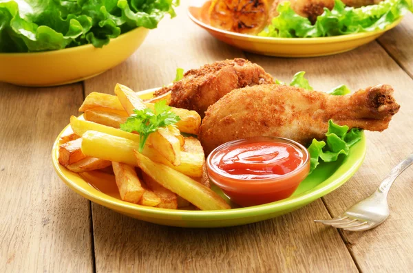 Fried drumsticks with french fries
