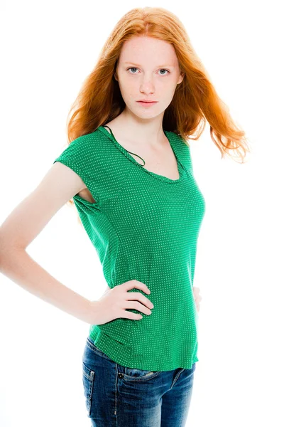 Pretty girl with long red hair wearing green shirt. Natural beauty. Fashion studio shot isolated on white background.