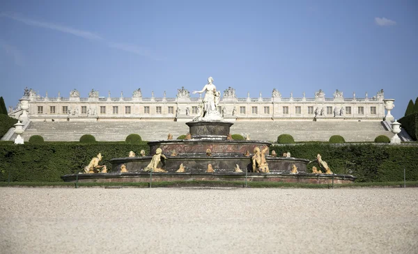 Sculpture of a mother and childs in garden the Royal Palace of Versailles, France