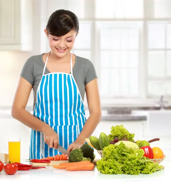 Beautiful woman cutting vegetables
