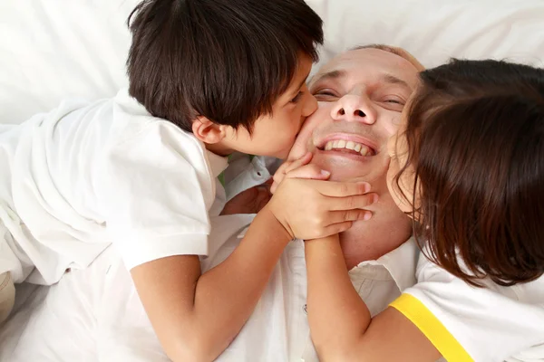 Son kissing their father