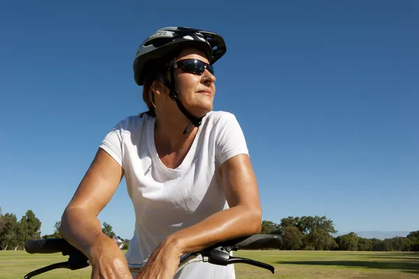 Confident and happy healthy mature female cyclist