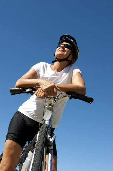 Confident and happy healthy mature female cyclist