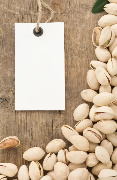 Pistachios nuts and tag price label on wood