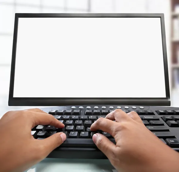 Hand typing keyboard with blank monitor