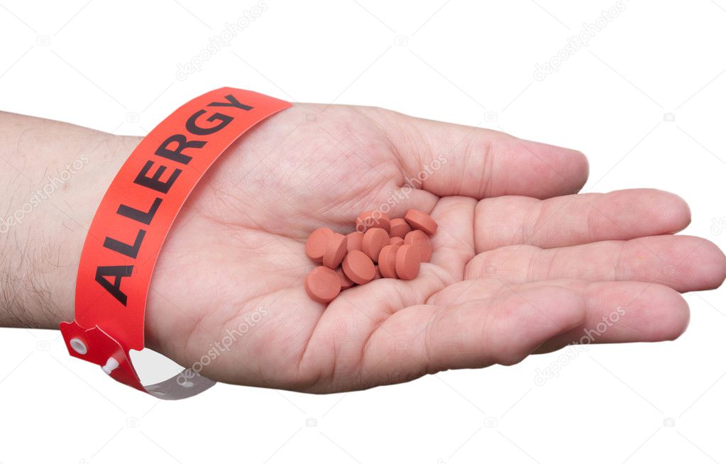 Hand With Allergy Wrist Band And Medicine — Stock Photo © Enigmangels