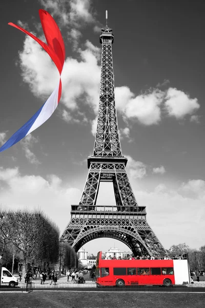 Famous Eiffel Tower with colorful flag in Paris, France