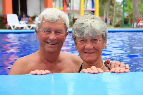 Senior couple in swimming pool.