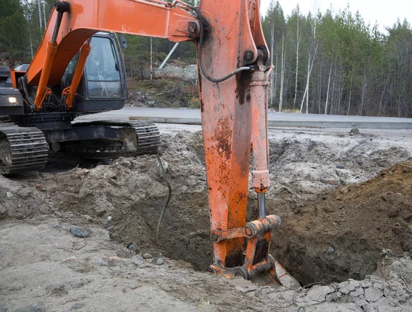 Backhoe digging trench