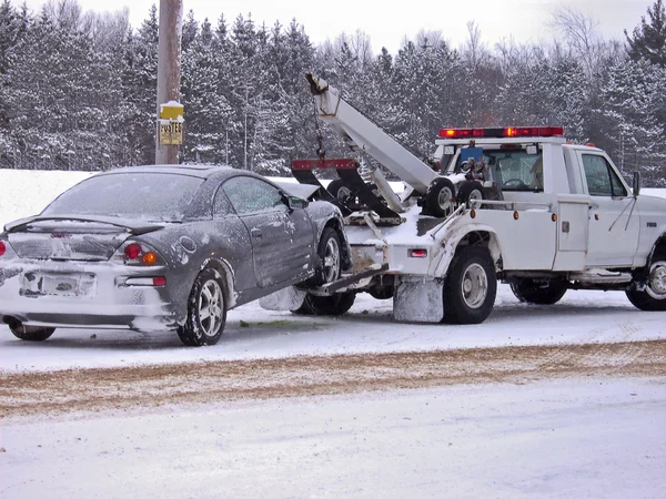 Tow truck towing a wrecked car