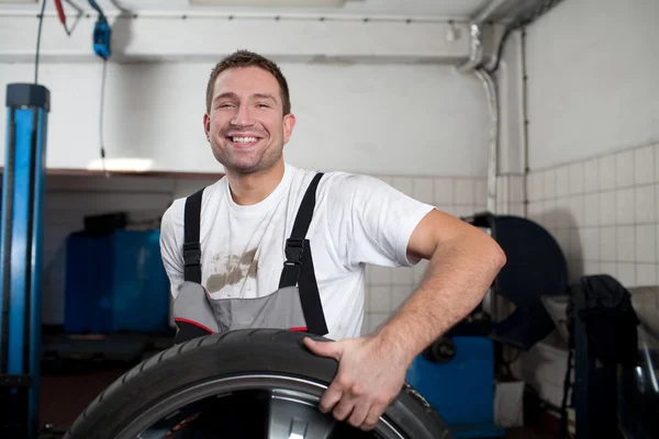 Mechanic smiling at work