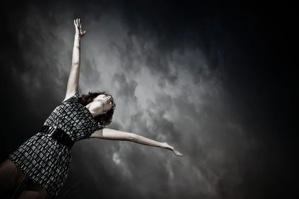 Girl stretching arms into the sky